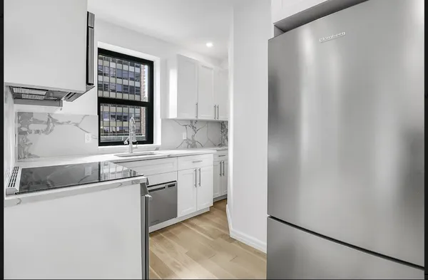 a kitchen with a sink cabinets and window