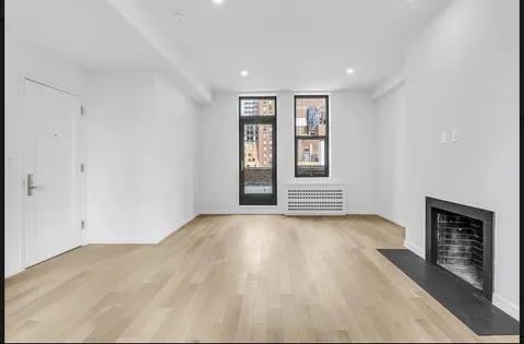 wooden floor in an empty room with a fireplace