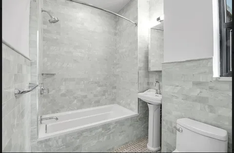 a bathroom with a bathtub and a shower
