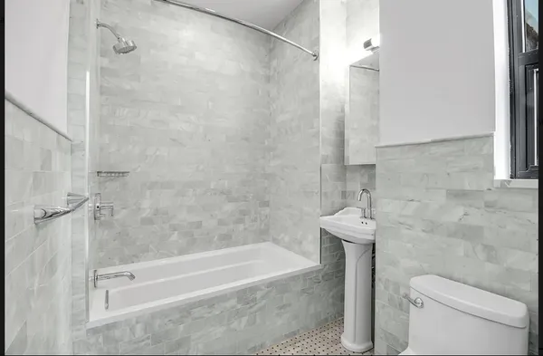 a bathroom with a bathtub and a shower