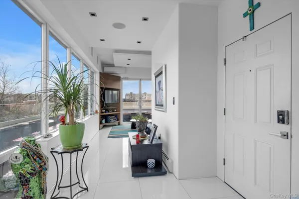 a living room with furniture and a potted plant