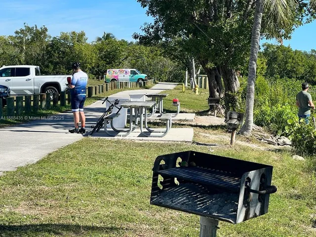 a view of backyard with seating area and trees