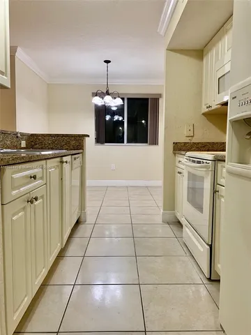 a kitchen with stainless steel appliances granite countertop a stove top oven and cabinets