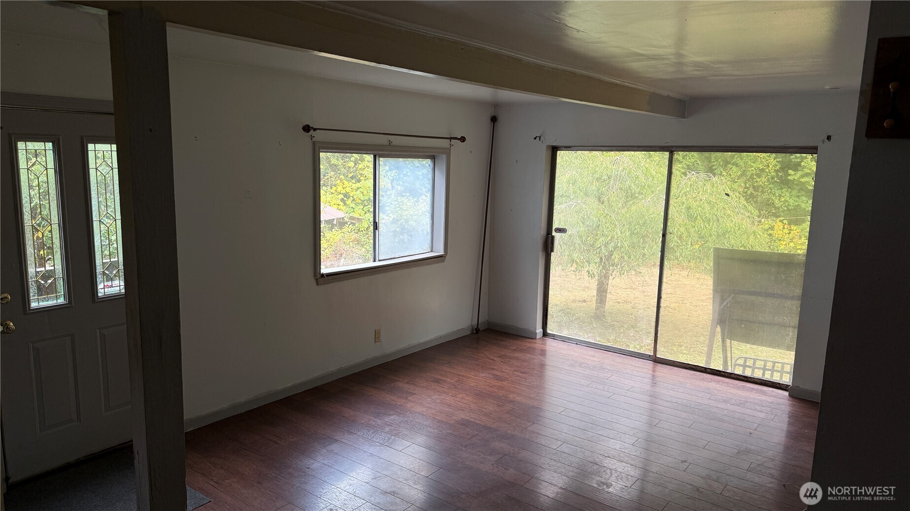 690 Naylor Creek Road Chimacum, WA 98325 - Photo 11 of 40 a view of an empty room with wooden floor and a window