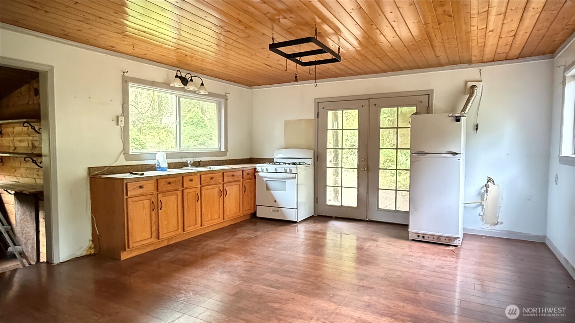 690 Naylor Creek Road Chimacum, WA 98325 - Photo 14 of 40 a large kitchen with stainless steel appliances granite countertop a stove a sink and a refrigerator