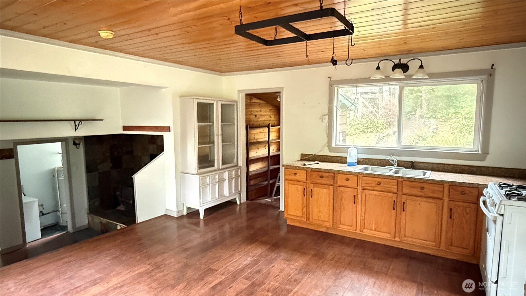 690 Naylor Creek Road Chimacum, WA 98325 - Photo 15 of 40 a kitchen with stainless steel appliances granite countertop a sink and cabinets with wooden floor