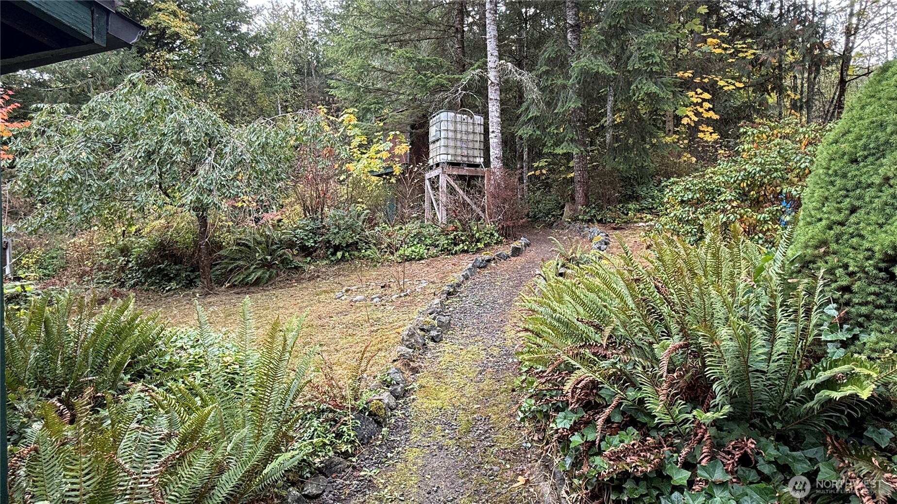 690 Naylor Creek Road Chimacum, WA 98325 - Photo 7 of 40 a backyard of a house with a yard and outdoor seating
