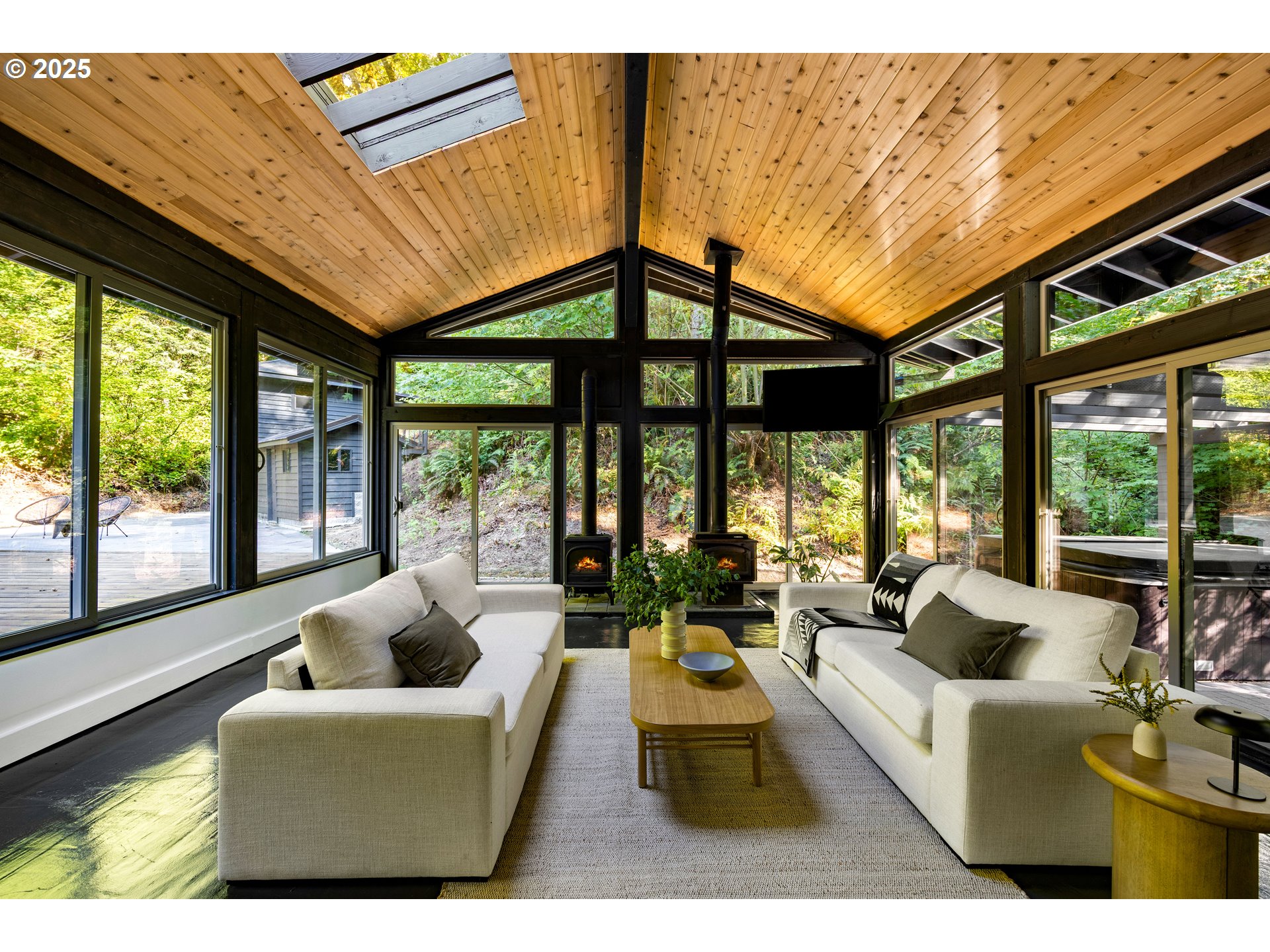 6125 Northwest Thompson Road Portland, OR 97210 - Photo 27 of 39 a living room with furniture tv and large windows