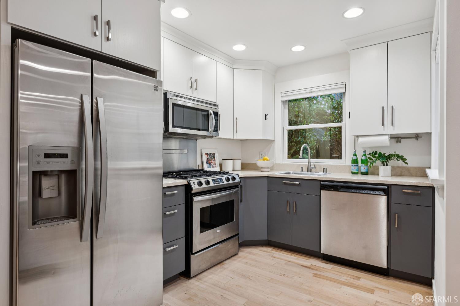 32 Harris Place, Unit A San Francisco, CA 94123 - Photo 5 of 9 a kitchen with stainless steel appliances a refrigerator sink and microwave