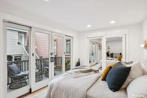 a bedroom with a bed and large window