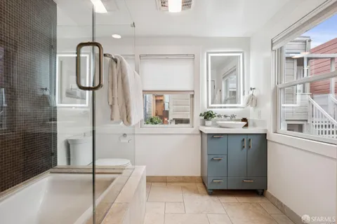 a bathroom with a bathtub and a shower