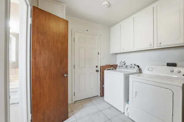 a view of storage and utility room with washer and dryer