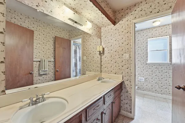 a bathroom with a sink a vanity and a mirror