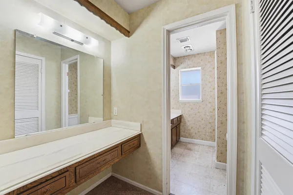 a bathroom with a sink a vanity and a mirror