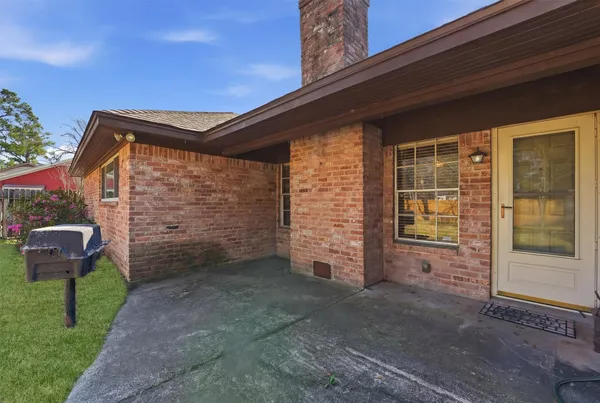 a backyard of a house with table and chairs