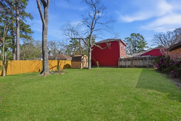 a view of house with backyard