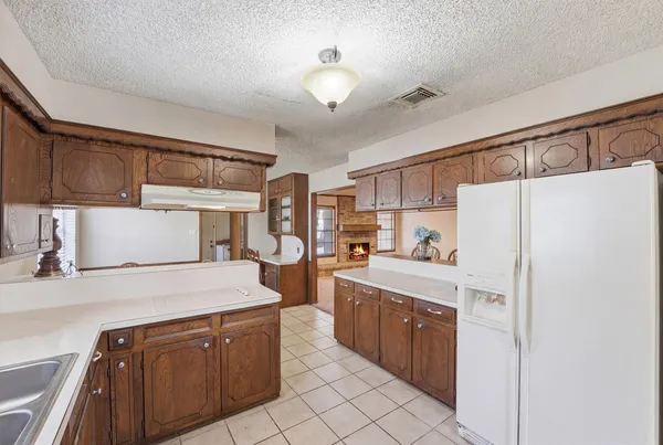 a kitchen with stainless steel appliances a refrigerator sink and cabinets