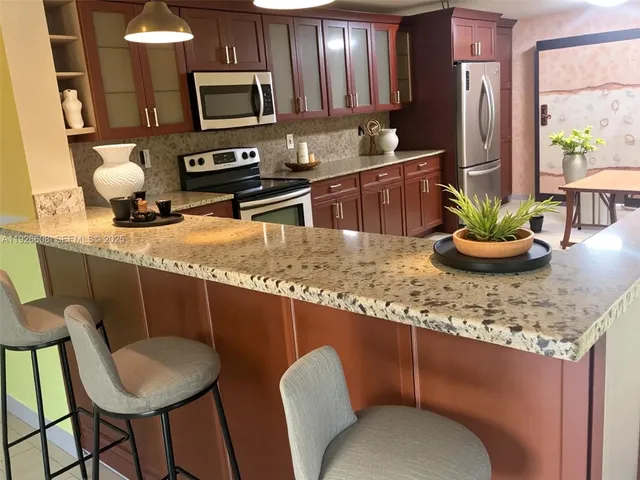a kitchen with a table chairs sink and microwave