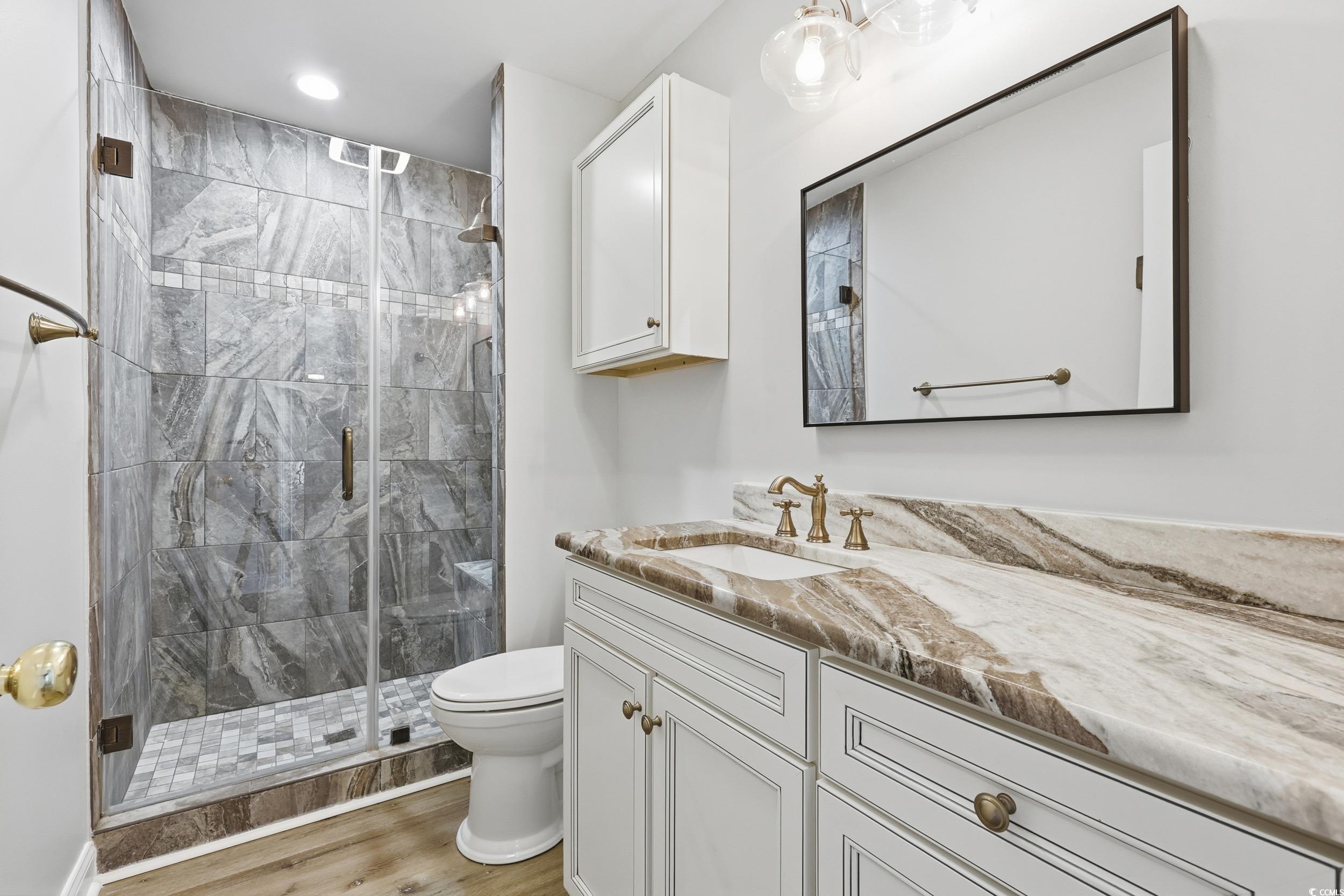 4337 State Highway 65 Conway, SC 29526 - Photo 13 of 39 Full bathroom featuring a stall shower, vanity, and light wood-style flooring