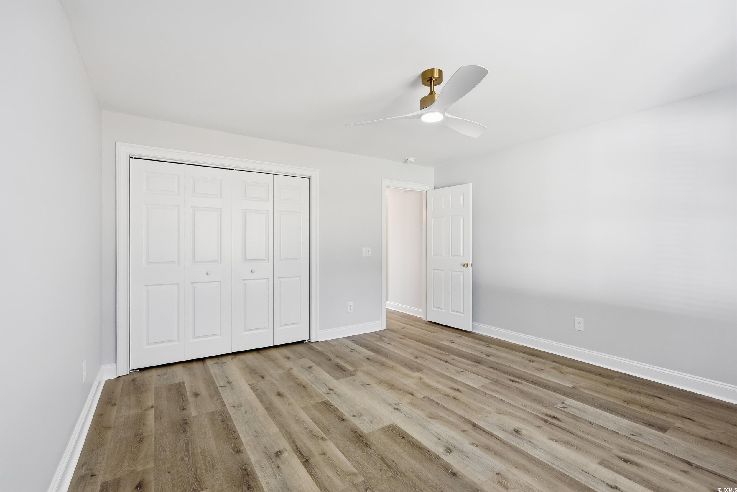 4337 State Highway 65 Conway, SC 29526 - Photo 15 of 39 Unfurnished bedroom featuring light wood-style flooring, ceiling fan, and a closet