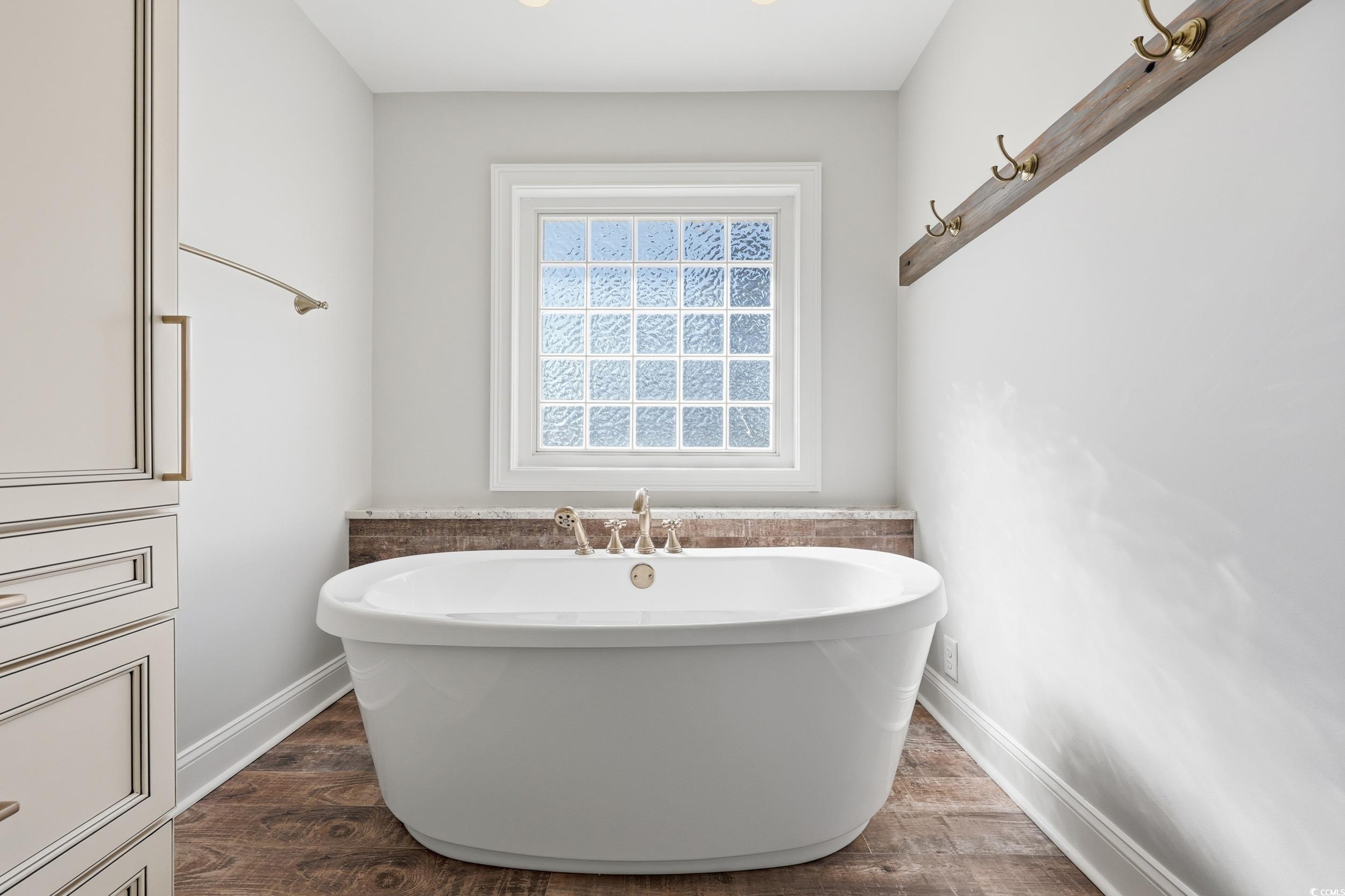 4337 State Highway 65 Conway, SC 29526 - Photo 20 of 39 Bathroom featuring dark wood-style flooring and a soaking tub