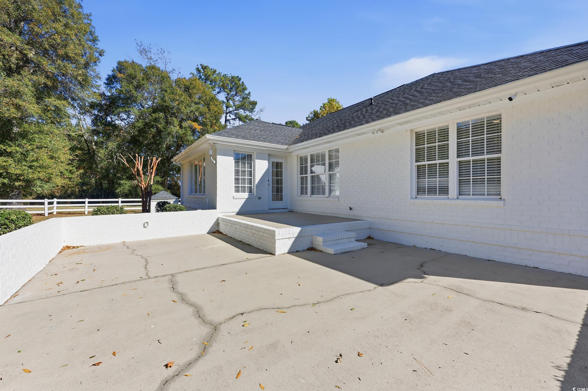 4337 State Highway 65 Conway, SC 29526 - Photo 23 of 39 View of property exterior with a patio area, brick siding, and a shingled roof