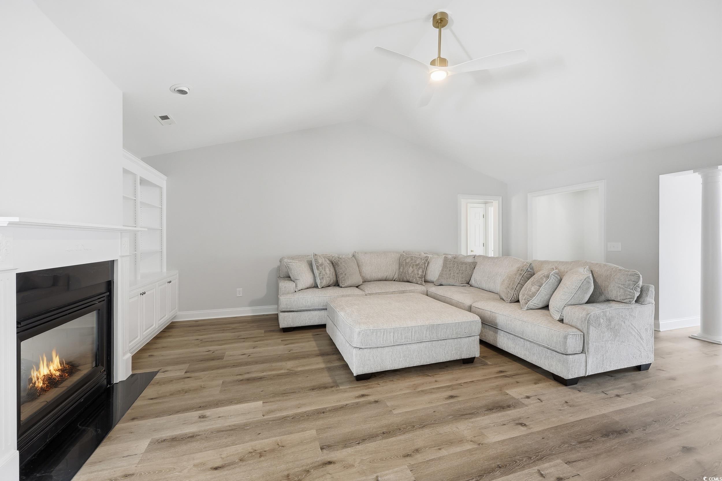 4337 State Highway 65 Conway, SC 29526 - Photo 6 of 39 Living area with light wood-style flooring, ceiling fan, a glass covered fireplace, and lofted ceiling