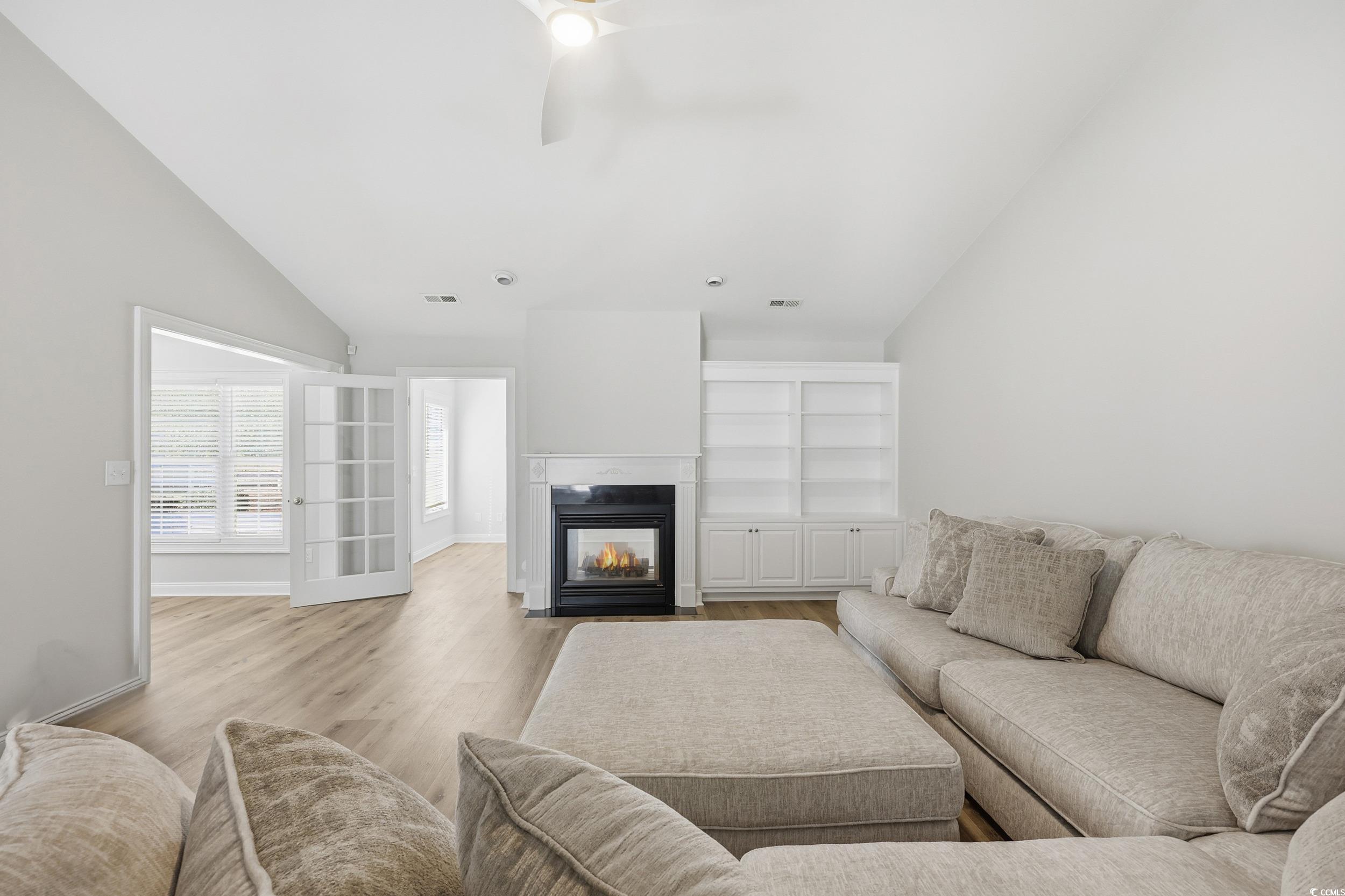 4337 State Highway 65 Conway, SC 29526 - Photo 7 of 39 Living area featuring lofted ceiling, a multi sided fireplace, light wood-style floors, and a ceiling fan