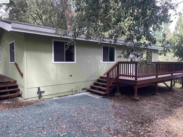 a view of backyard with deck and outdoor seating