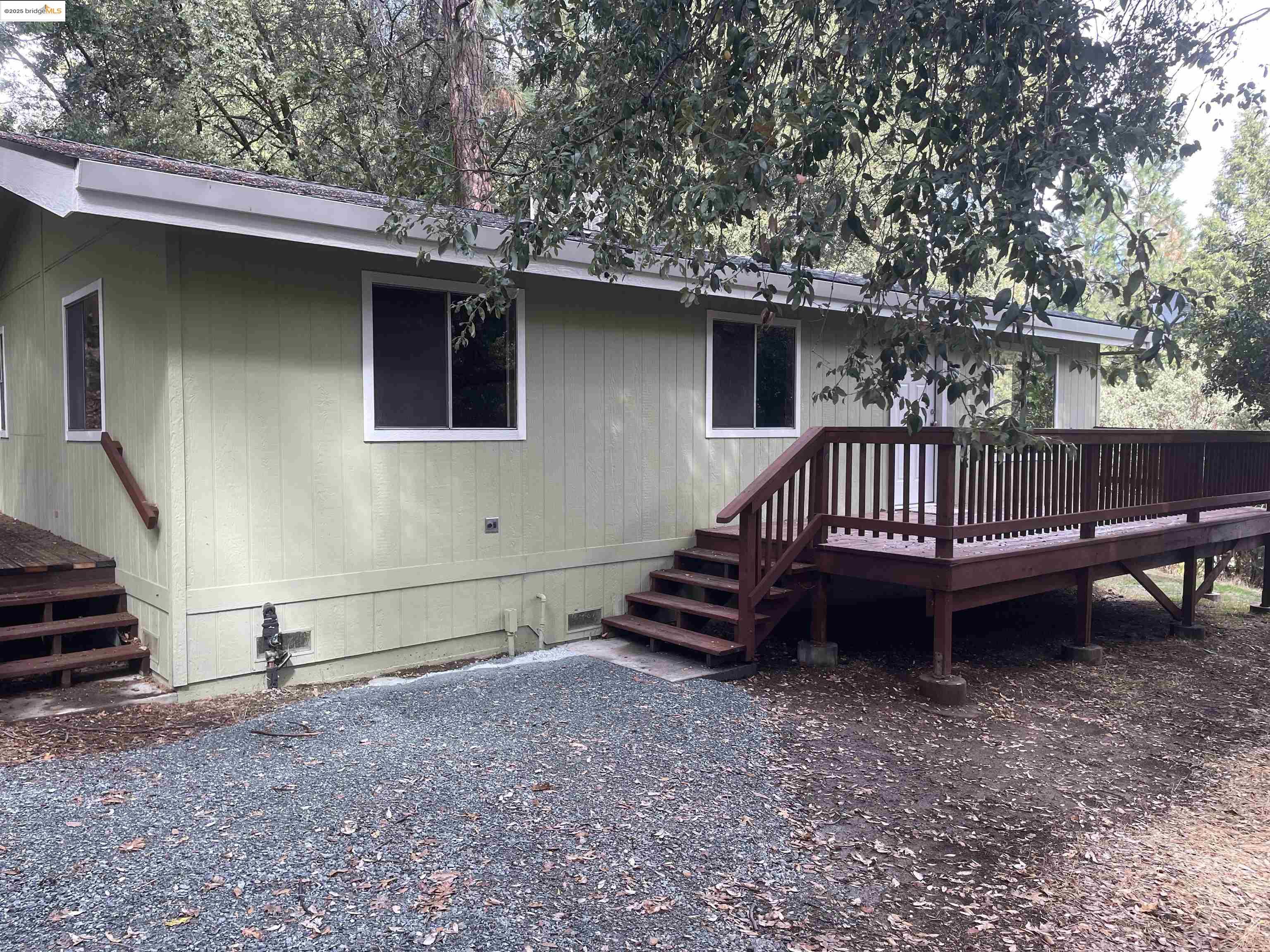 a view of backyard with deck and outdoor seating