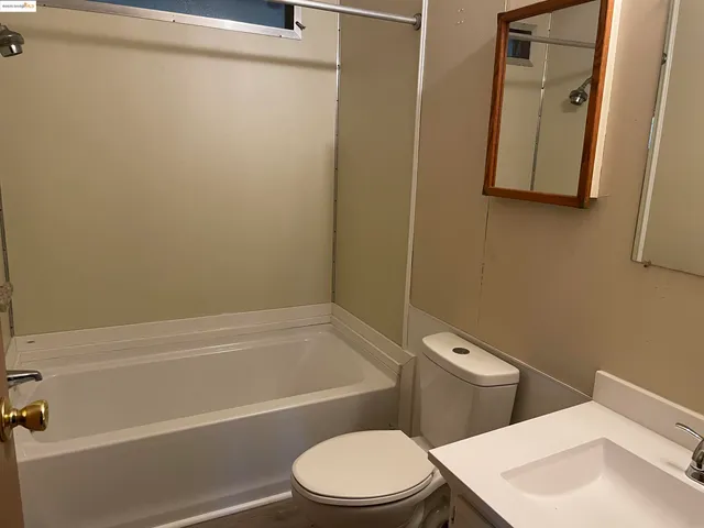a white toilet and tub next to a bathroom sink