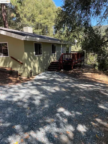 a front view of house with deck and yard