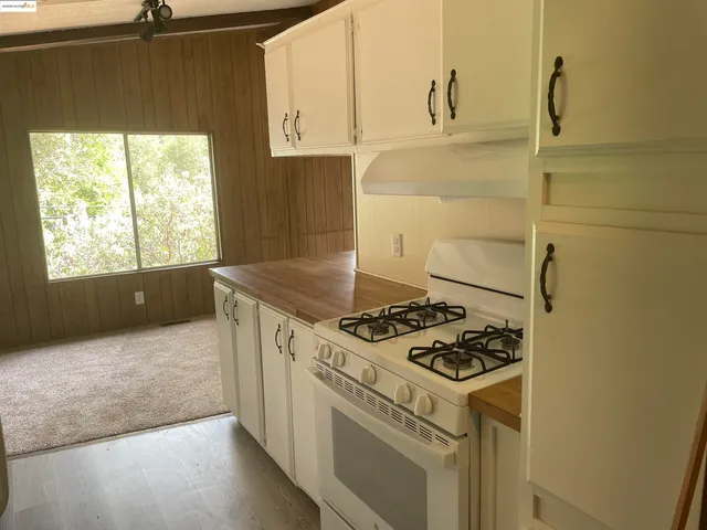 a kitchen with a stove and a refrigerator