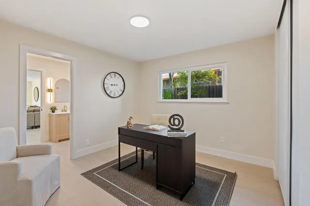 a view of a room that has a bench and a table in it