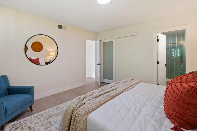 a bedroom with a bed couch and a window