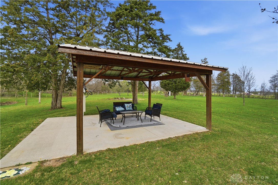 7553 Coffin Station Road Springfield, OH 45502 - Photo 20 of 95 Enjoy outdoor living under this spacious covered patio, perfect for relaxation and entertaining.