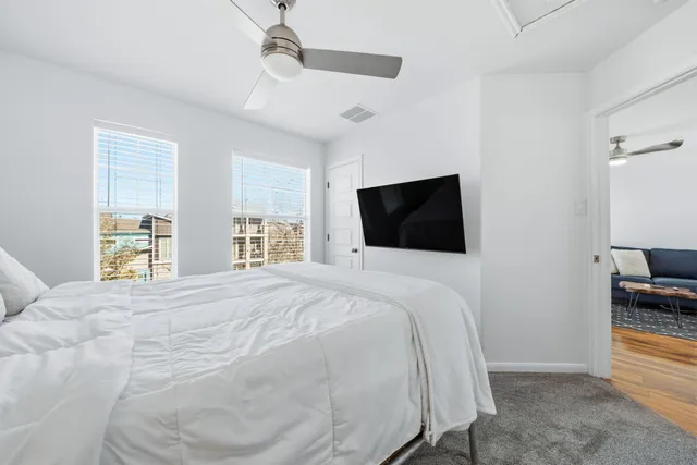 a large bedroom with a bed and a television