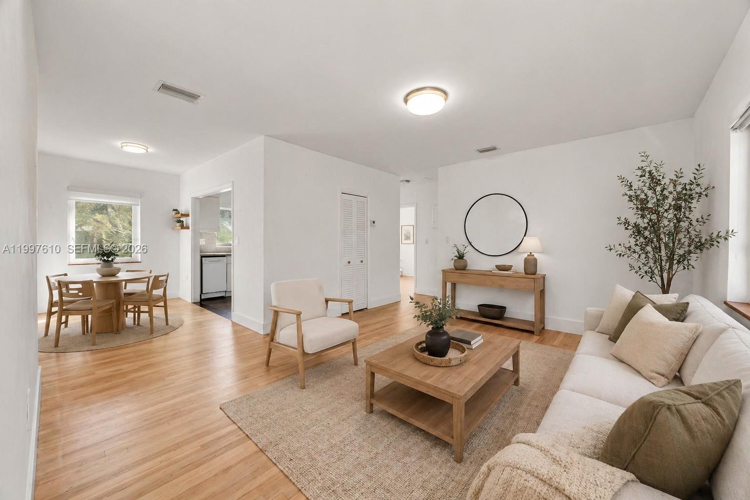 5510 Southwest 76th Street, Unit C Miami, FL 33143 - Photo 2 of 14 a living room with furniture a dining table with rug stove and wooden floor