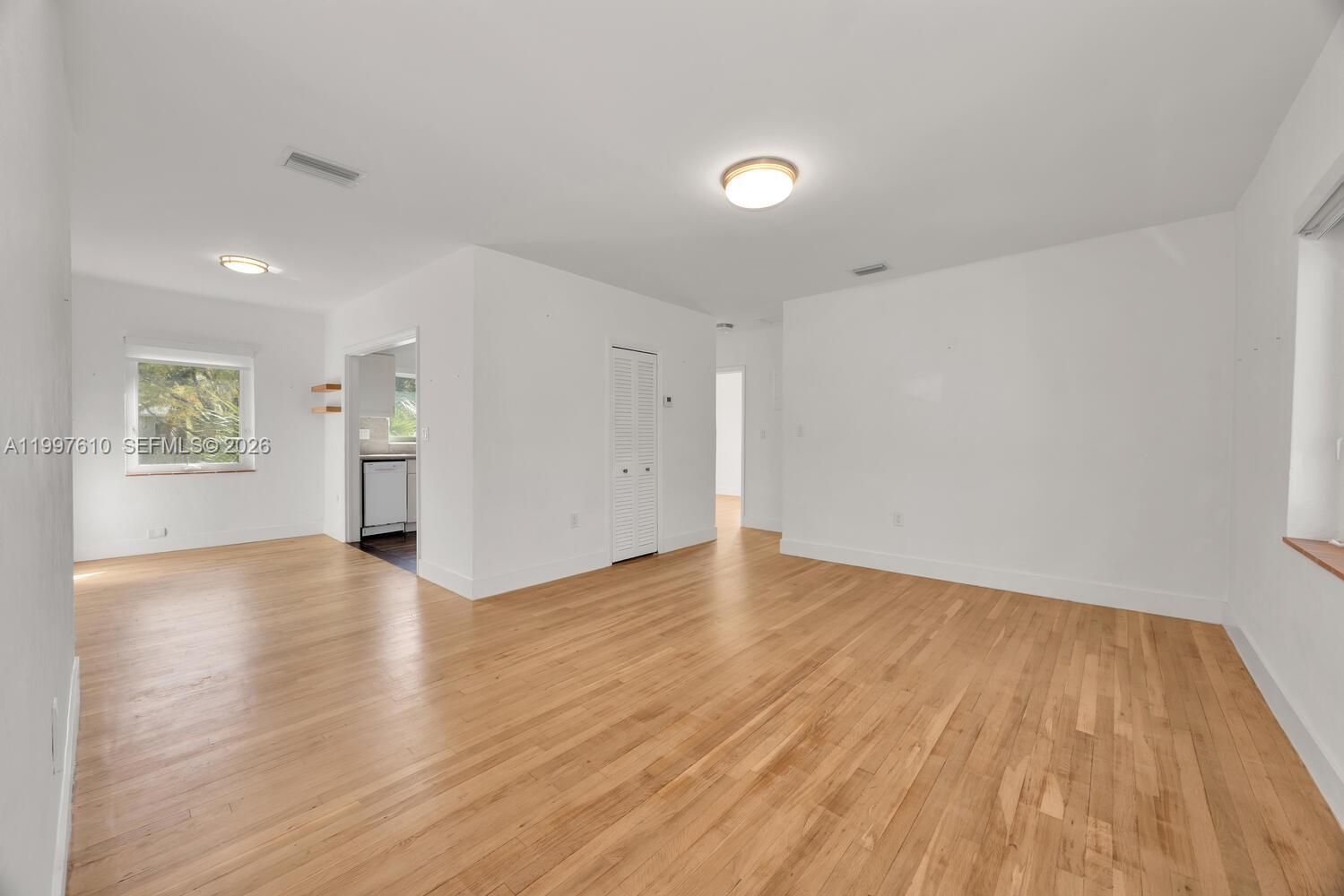 5510 Southwest 76th Street, Unit C Miami, FL 33143 - Photo 3 of 14 a view of empty room with wooden floor and fan
