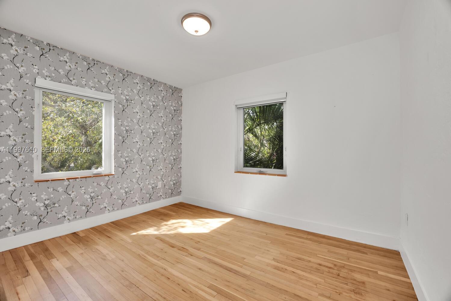 5510 Southwest 76th Street, Unit C Miami, FL 33143 - Photo 7 of 14 an empty room with a window
