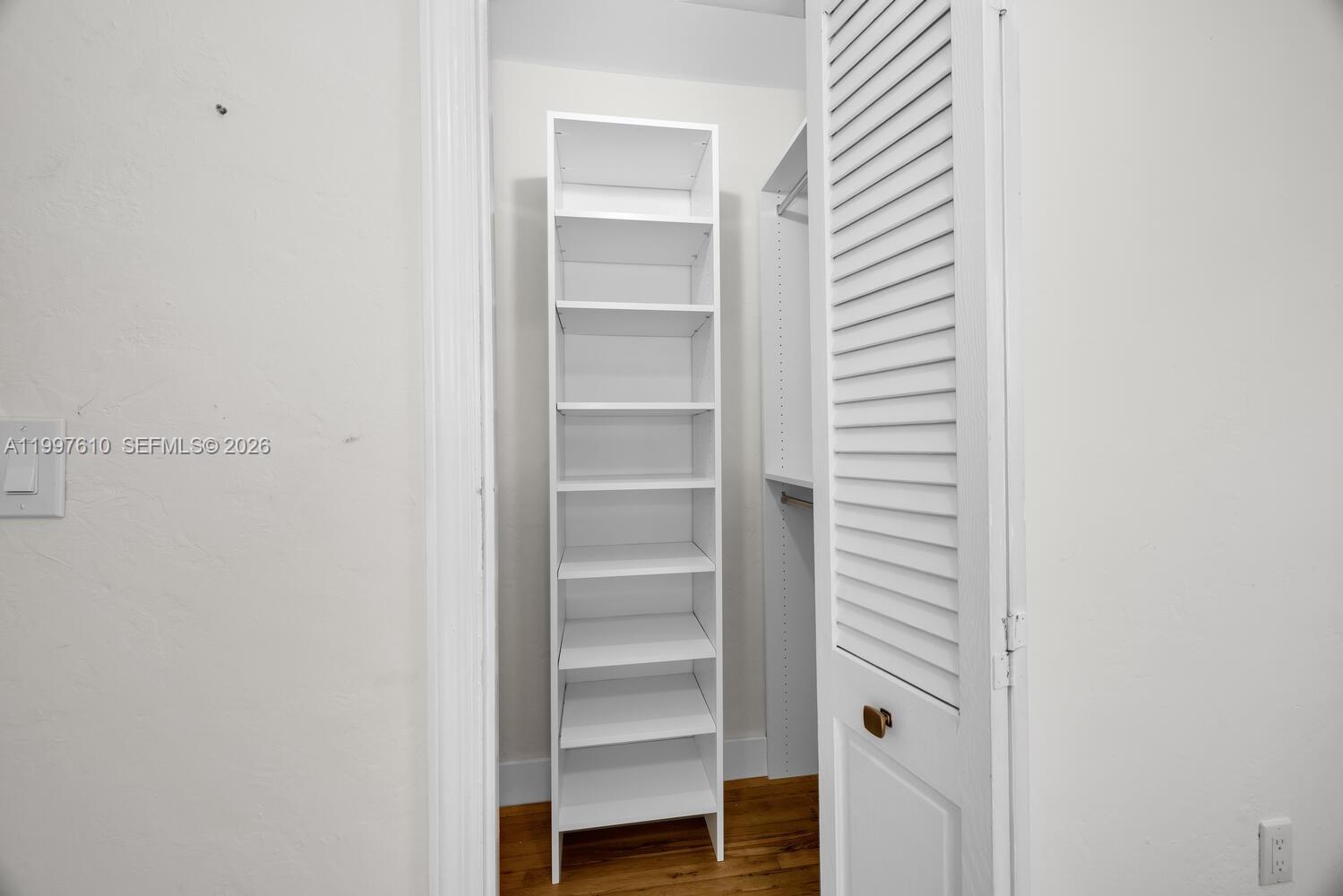 5510 Southwest 76th Street, Unit C Miami, FL 33143 - Photo 10 of 14 a view of walk in closet with empty racks