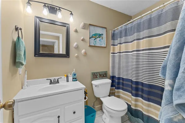 a bathroom with a toilet a sink and a mirror