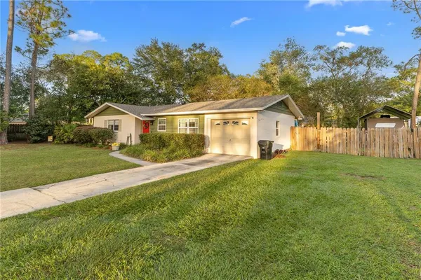 a front view of house with yard and green space
