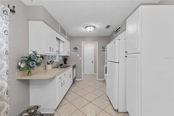 a spacious bathroom with a double vanity sink a mirror and a shower