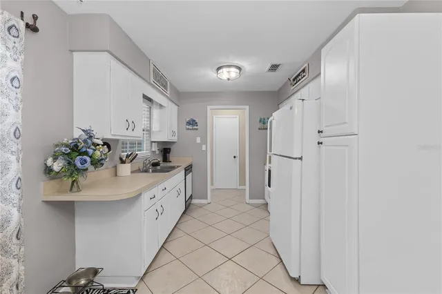 a spacious bathroom with a double vanity sink a mirror and a shower