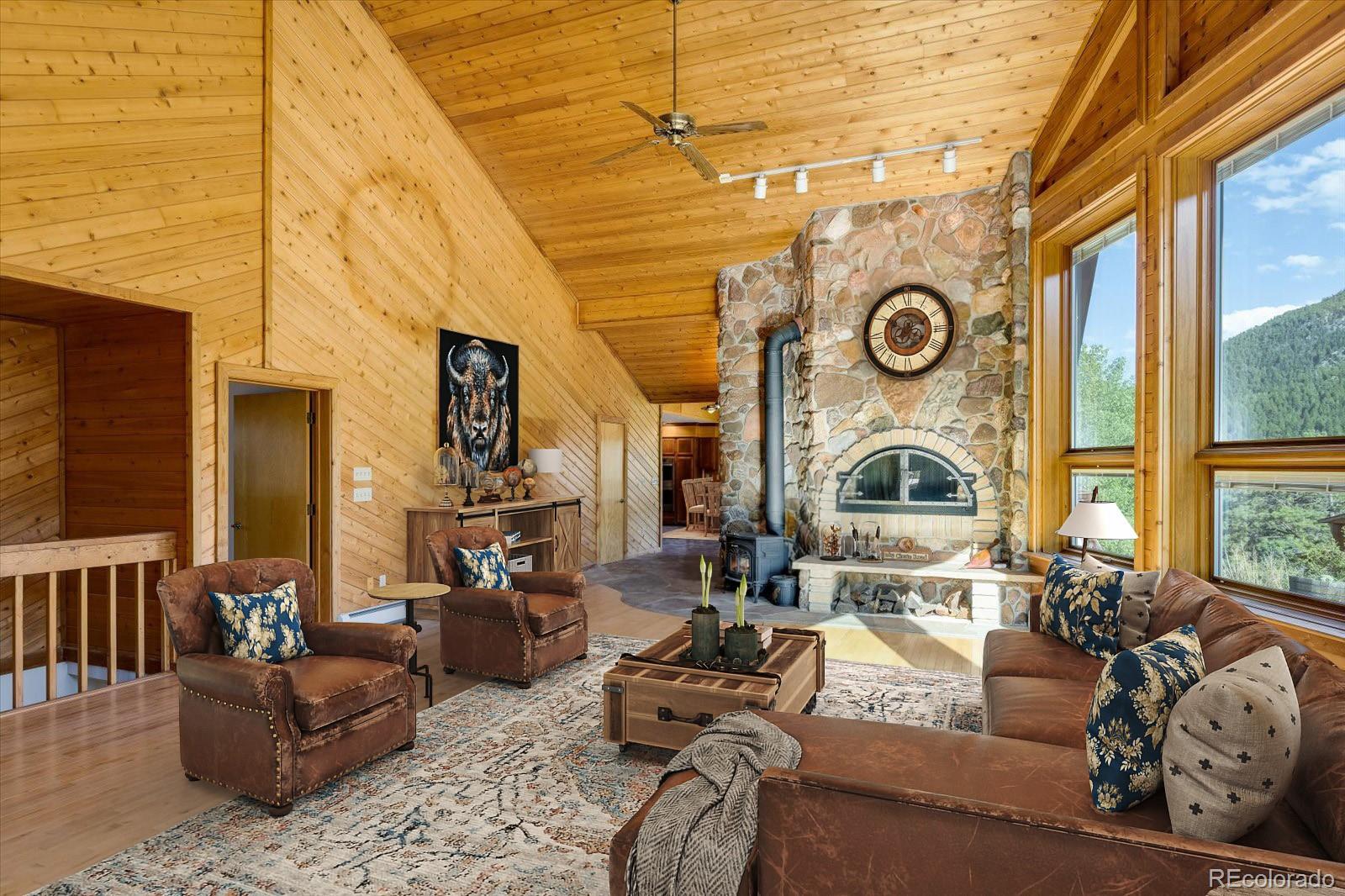 283 Chute Road Golden, CO 80403 - Photo 13 of 40 a living room with fireplace furniture and a large window