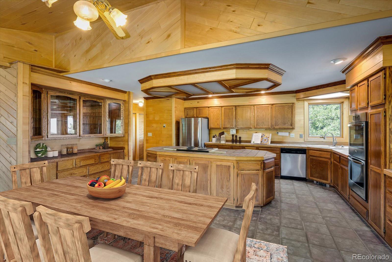 283 Chute Road Golden, CO 80403 - Photo 14 of 40 a kitchen with stainless steel appliances granite countertop a sink and wooden cabinets