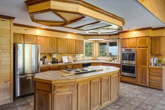 a kitchen with stainless steel appliances granite countertop a stove a refrigerator and a refrigerator