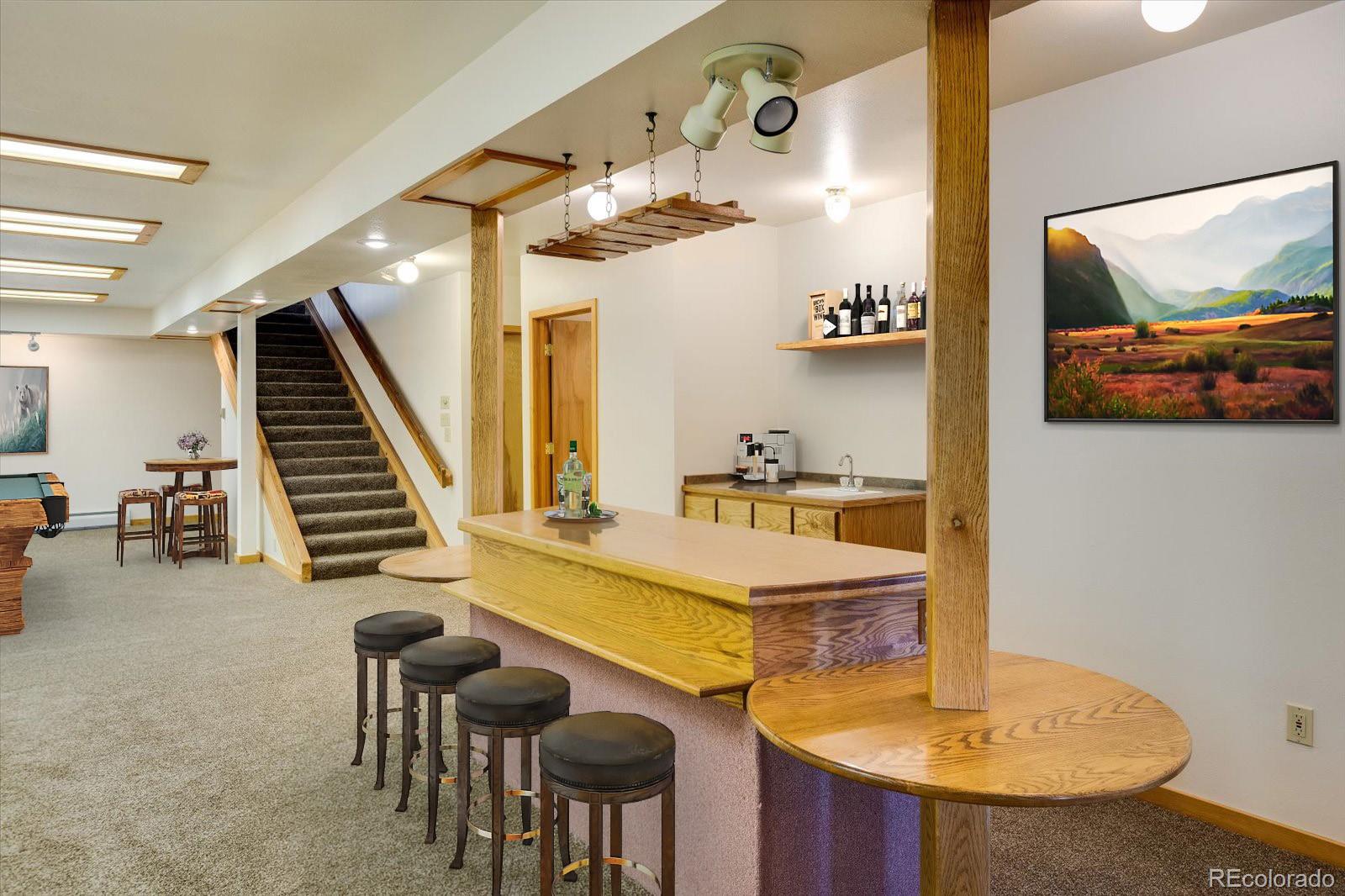 283 Chute Road Golden, CO 80403 - Photo 30 of 40 a view of a dining room with furniture and wooden floor