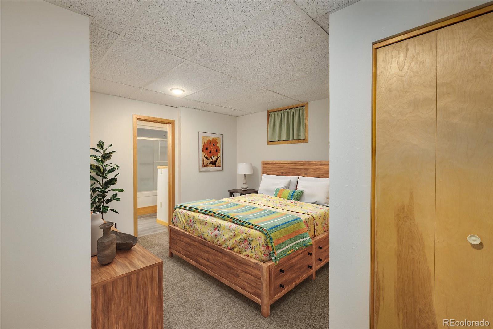 283 Chute Road Golden, CO 80403 - Photo 32 of 40 a bedroom with a bed and a table in it